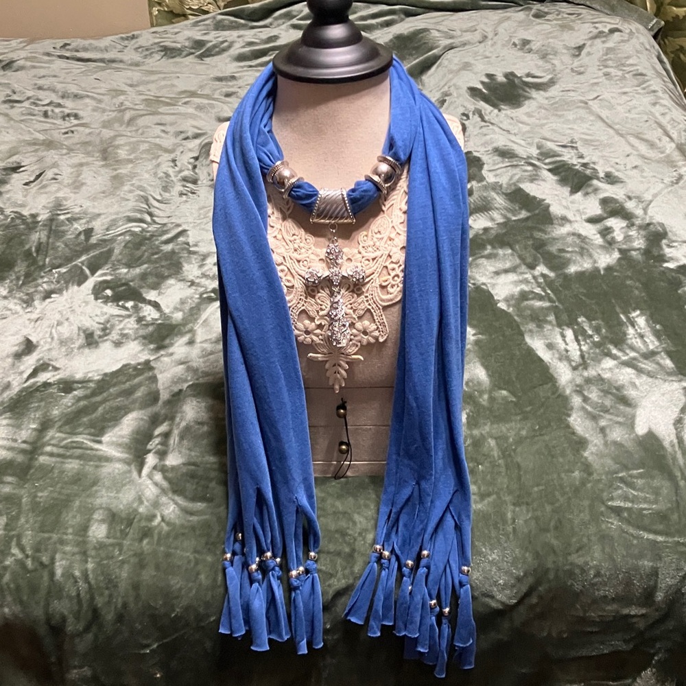 Royal blue scarf necklace with a rhinestone cross, pendant and silver tone beads